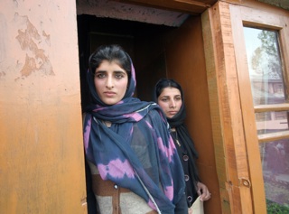 Ishrat Ara, 16, and her older sister Shagufta, 19, stand in the doorway of the house outside Srinagar, India, where her mother was shot and killed by Indian forces in September while standing on a balcony. Ara and other young residents of Kashmir are calling on U.S. President Barack Obama to speak out about the recent turmoil in Kashmir when he visits India this weekend. (Dion Nissenbaum/MCT)