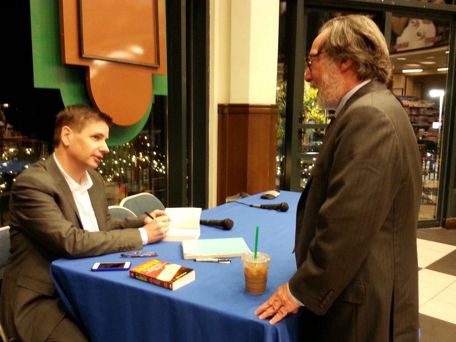 Author Dan Morse signs a book for citizen Steven Kupferberg. Photo by Marissa Nardella.