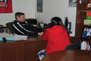Counselor Dennis Reynolds helps a student select classes for next school year. 