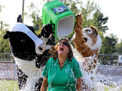 Principal Jennifer Baker is soaked in ice water by school mascots to benefit ALS. 