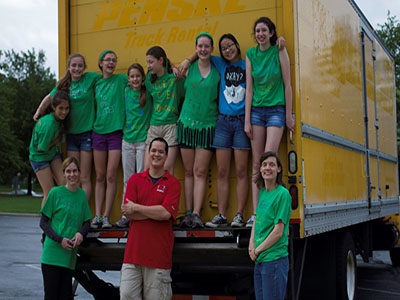 Members of the Together to End Hunger Club help out at the 2013 packaging event. Top, from left: junior Gabriela Morris-Flores, junior Brynna Gleeson, junior Emma Pannullo, elementary schooler Christina Pannullo, middle schooler Victoria Pannullo, junior Caitlin Trenkle, junior Madeleine Gefke, and junior Julia Hirsch. Bottom, from left: club sponsor Erin Besch, Stop Hunger Now helper Dominic Alexander, and parent Holly Pannullo. 