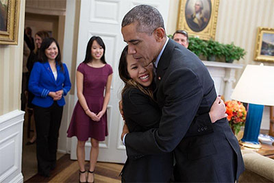 Pham and President Obama embrace in the Oval Office on Friday, October 24, 2014.