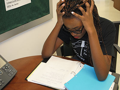 Joyce Mbogba, a stressed-out senior at WJ, frantically studies. 
