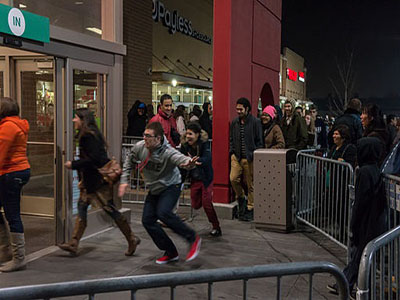 People sprint to check items off their shopping list when the doors open on Black Friday.