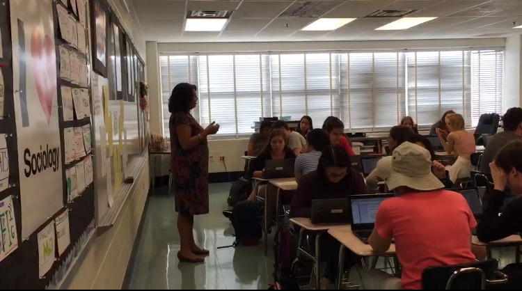Sociology teacher, Geri Acquard, talks to her students about relationships between parents and kids. 