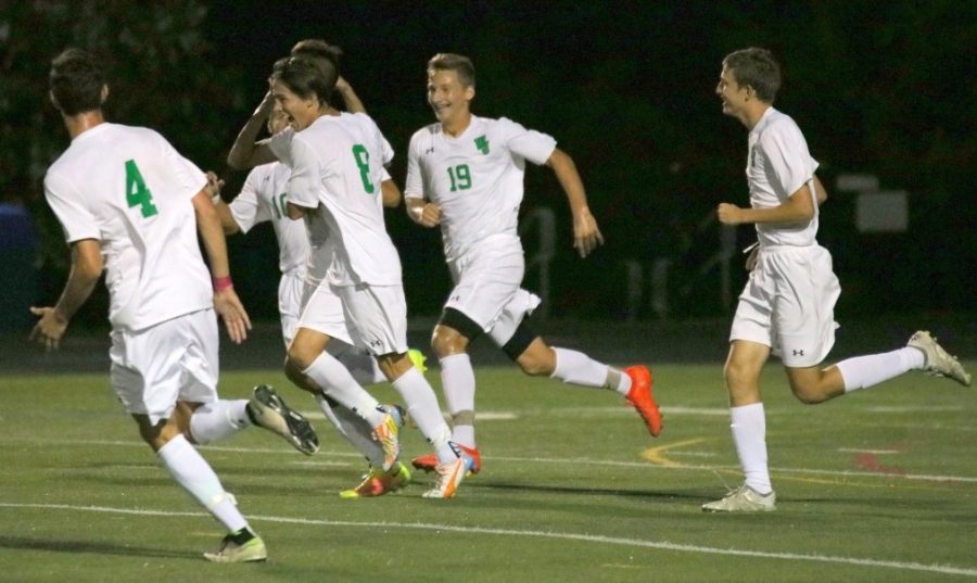 Players on the boys soccer team congratulate each after scoring a goal in a 3-1 win against Bethesda-Chevy Chase High School on September 13. Photo courtesy of WJ Athletics.