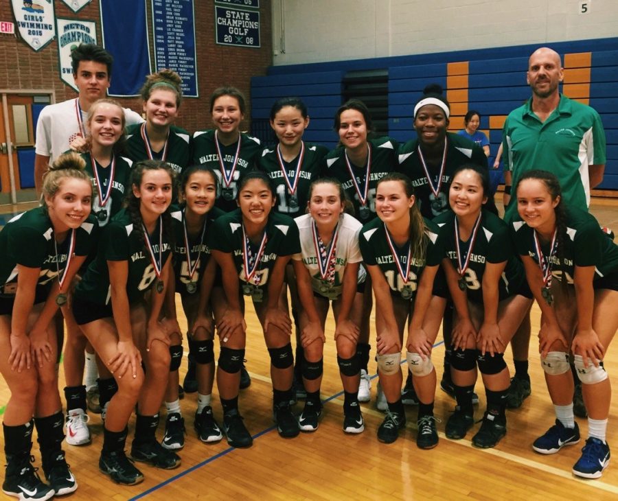 (Girls Volleyball posing with their medals after finishing second place after the Tournament at Churchill.)