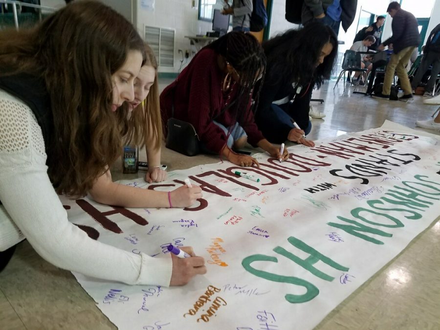 WJ students sign a banner with their names and nice messages that will be sent to  Marjory Stoneman Douglas High School in Florida. Photo courtesy of Wendy Borrelli.