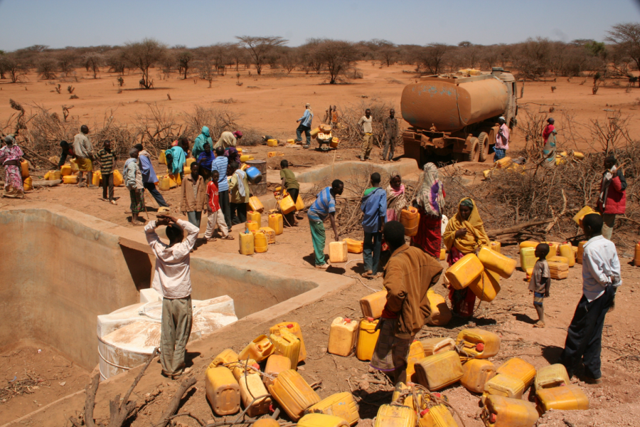 People line up to collect their daily rations of water. The government has to carefully monitor the distribution of water to ensure that people are getting the right amount and more importantly, not too much.  Photo courtesy of Wikimedia Commons.