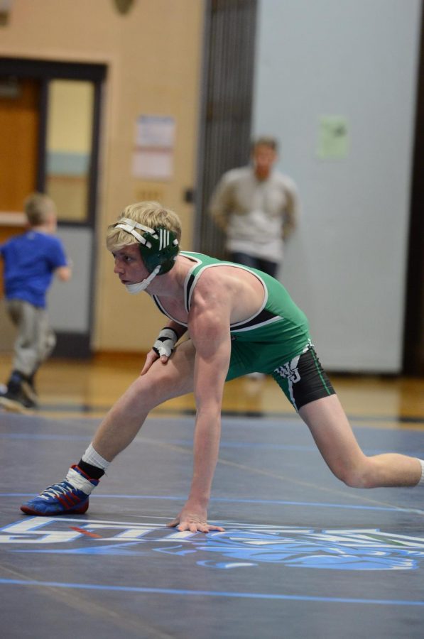 Senior+Wrestler+Kemper+Stearns+rises+to+his+feet.+Stearns+placed+second+in+the+state+within+his+weight+class.