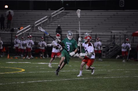 Junior Ethan Opdahl keeps the ball away from a Blair defender.  Although the team has struggled, Opdahl has been a bright spot, helping to keep the Wildcats competitive.  Already a captain as a junior, Opdahl supplies guidance for younger players both on and off the field.  He is defensive stalwart for the ‘Cats, and has already committed to play Division 1 lacrosse for the Bucknell University.  The season has certainly had its ups and downs.  The team has had exhilarating victories like an 11-10 win over Springbrook and some poor losses like an 18-2 blowout loss against Churchill High School.  But as long as Opdahl is anchoring the defense, the ‘Cats have a chance to win. Photo courtesy of Lifetouch Studios.