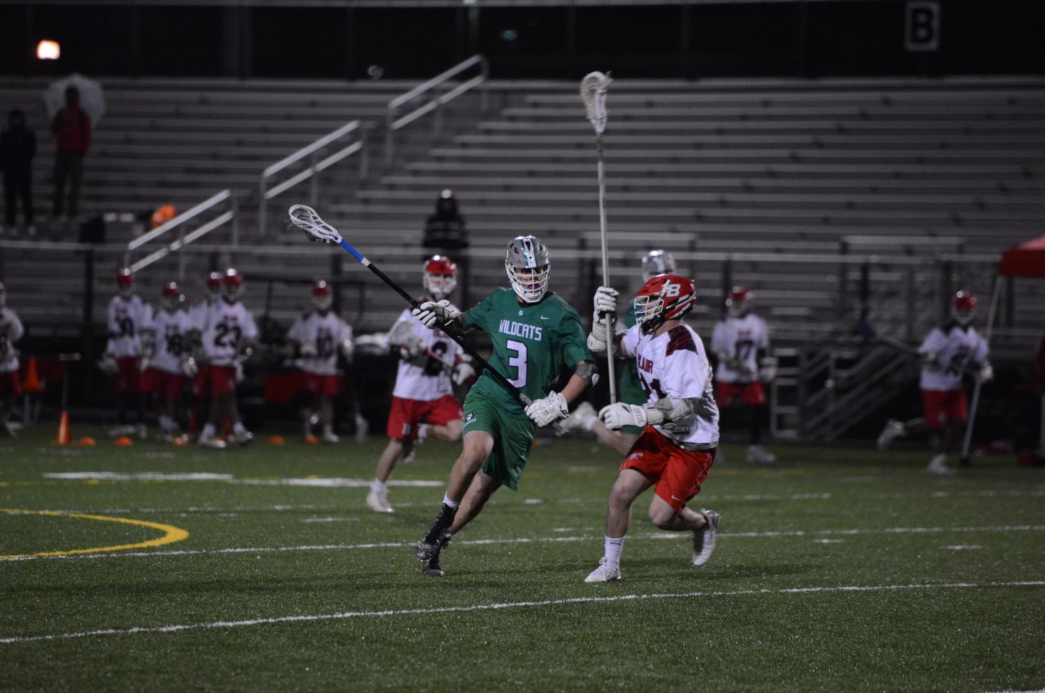 Junior Ethan Opdahl keeps the ball away from a Blair defender. Although the team has struggled, Opdahl has been a bright spot, helping to keep the Wildcats competitive. Already a captain as a junior, Opdahl supplies guidance for younger players both on and off the field. He is defensive stalwart for the ‘Cats, and has already committed to play Division 1 lacrosse for the Bucknell University. The season has certainly had its ups and downs. The team has had exhilarating victories like an 11-10 win over Springbrook and some poor losses like an 18-2 blowout loss against Churchill High School. But as long as Opdahl is anchoring the defense, the ‘Cats have a chance to win. Photo courtesy of Lifetouch Studios.