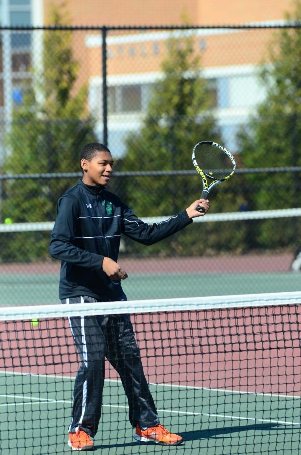 Junior Ian Greenwood returns a shot to his opponent. Boys tennis has a 3-2 record so far this season.