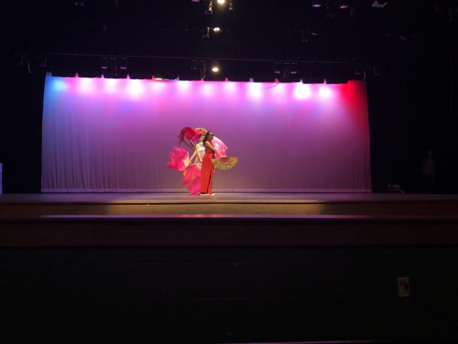 A traditional fan dance is performed to kick off the Asian Heritage Assembly. 