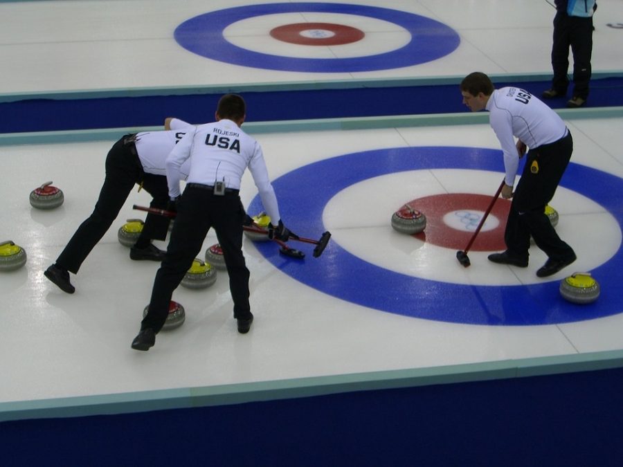 The US curling team sweeps a curling stone.  The US team certainly has nothing on the new WJ curling team, coming next year.  Photo courtesy of pixabay images.