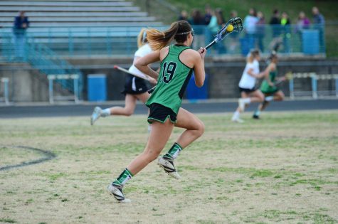 Senior captain Ashley Smith runs down the field, looking to go on the offensive. Girls lacrosse is off to a great start in the playoffs, winning both games so far against Einstein and Churchill.