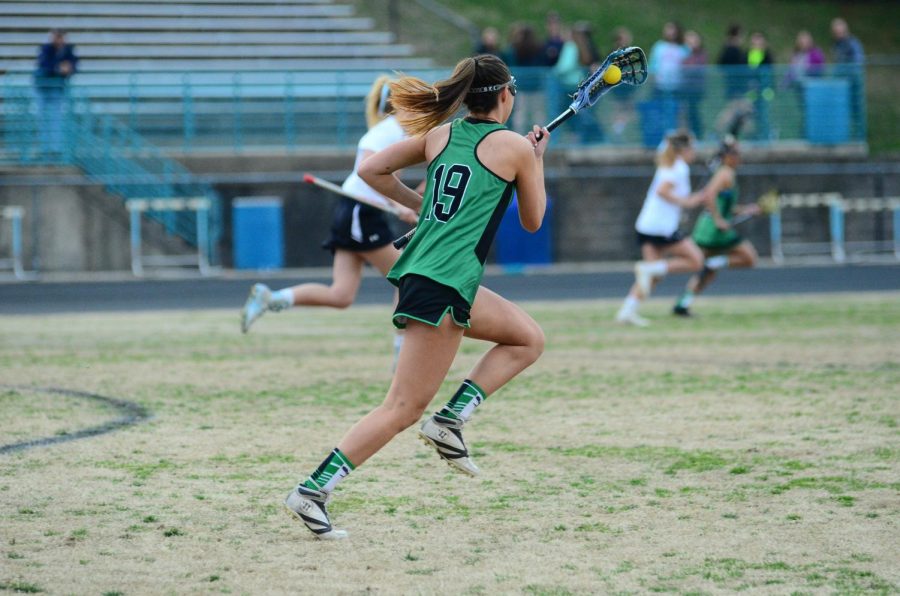 Senior captain Ashley Smith runs down the field, looking to go on the offensive. Girls lacrosse is off to a great start in the playoffs, winning both games so far against Einstein and Churchill.