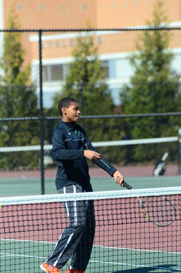 Junior Ian Greenwood hits a volley at the net. Boys tennis finished their regular season with an 8-4 record.