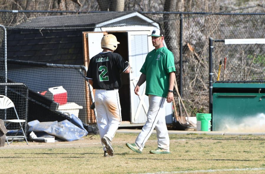 Junior outfielder Anthony Lacola converses with coach Steve Sutherland. WJ had a tough loss against Whitman in the first round 19-16. Courtesty of Lifetouch.