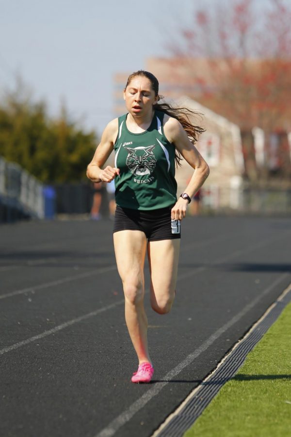 Abbey Green runs during a meet.  Green lead WJ to a great season this year. Photo Courtesy of Lifetouch Studios.