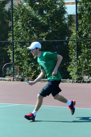 Senior captain Ethan Kowalski runs to return his opponents shot. Photo courtesy of Lifetouch Studios