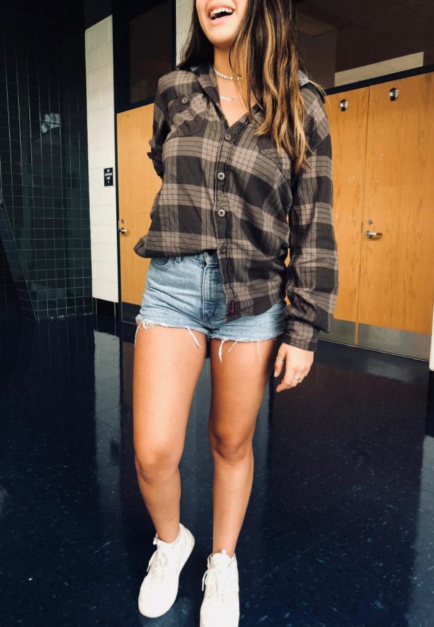 Senior+Simone+Giraldo+models+a+grungy+brown+flannel+with+a+partial+tuck+into+her+thrifted+cut+off+jean+shorts.+Her+delicate+silver+rings+and+layered+necklaces+added+a+girly+touch+to+the+outfit.