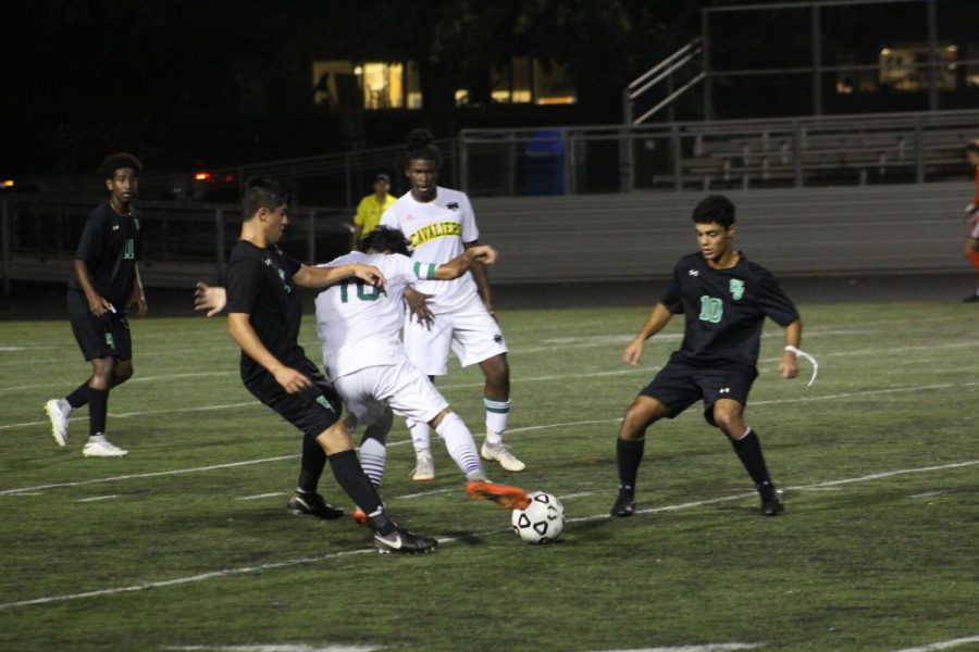 WJ fights for the ball in a game against Kennedy High School. The Wildcats have been looking to improve from last season.