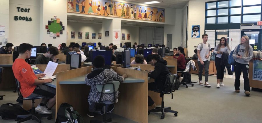 Students check out books and work on schoolwork in the Media Center. New additions to the media center in the past year have made it a crowded place during any breaks in school.