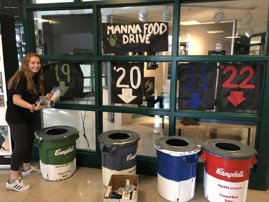 Senior Grace Burgett places some canned goods into the senior bin. She is part of the Leadership class that collects the donations at the very end of the fundraiser. 
