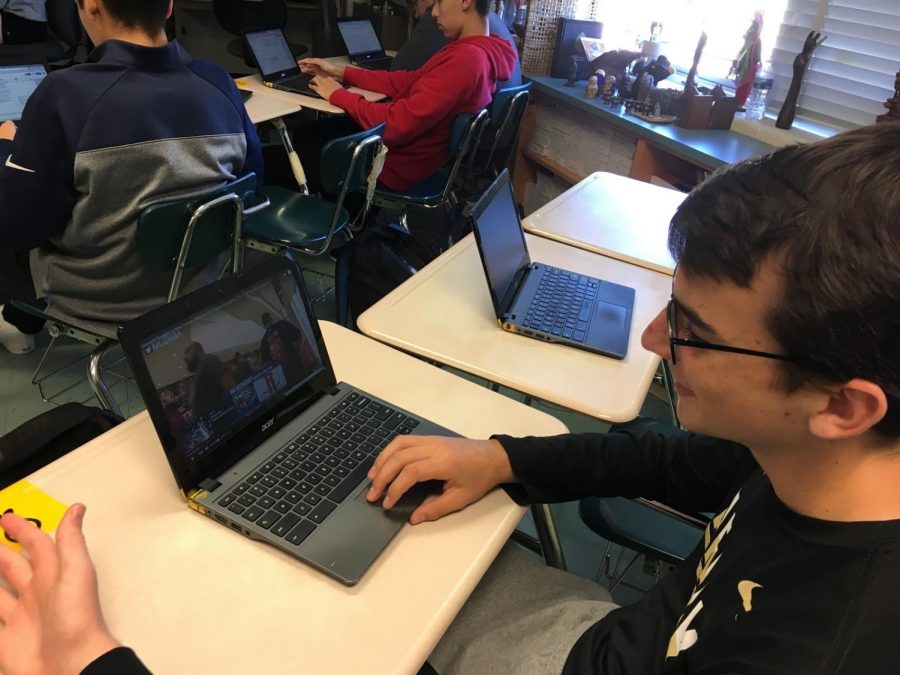 Junior Nate Koenick chooses to watch the highlights from a basketball game instead of completing his classwork. The new restrictions valid November 5 will eliminate misuse of YouTube.