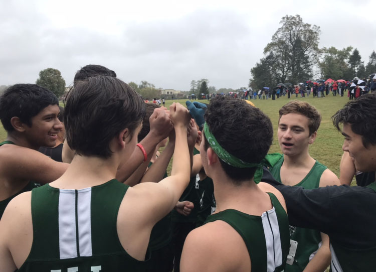 Boys+cross+country+prepares+for+the+county+championship+with+a+pre-race+pep+talk.+The+boys+ended+up+in+fifth+place+behind+Northwood%2C+Paint+Branch%2C+Wotton+and+Whitman+on+the+cold+rainy+day.%0A
