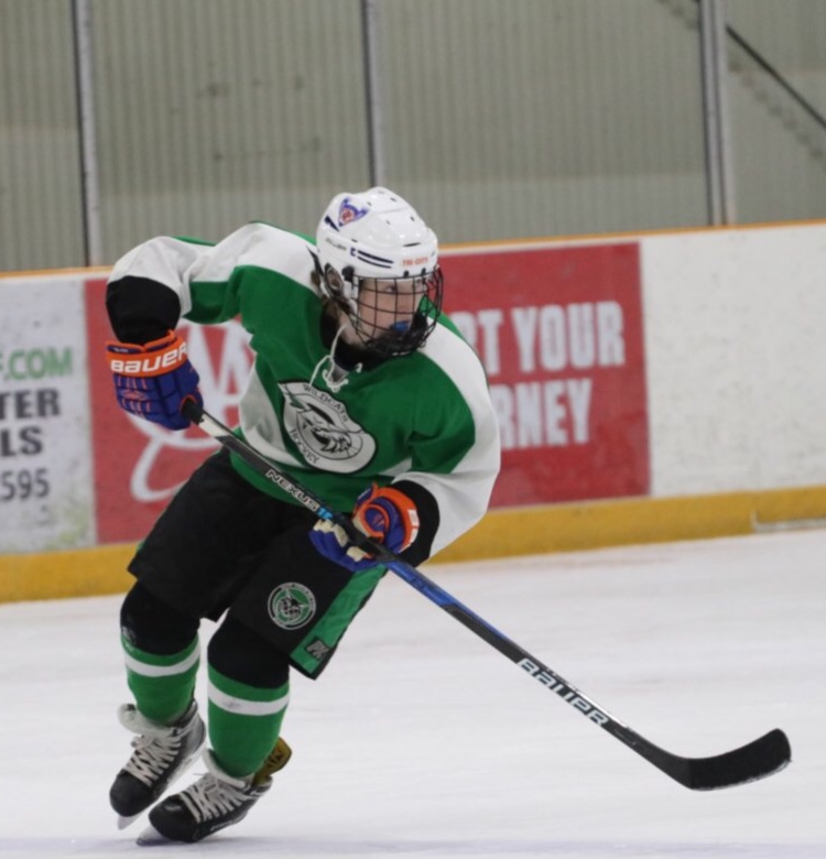 Junior Quinn Mulligan warms up for the game against BCC with a skate around. Mulligan had one goal and three assists for a game high four points, leading the Icecats to a 6-5 victory over rival BCC.
