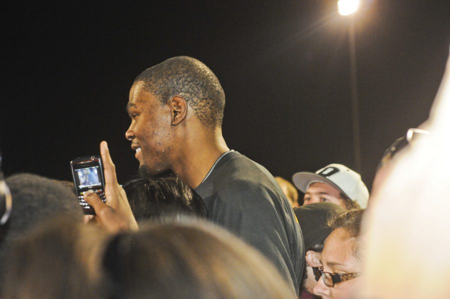 NBA star Kevin Durant on his phone during a basketball fundraiser. 