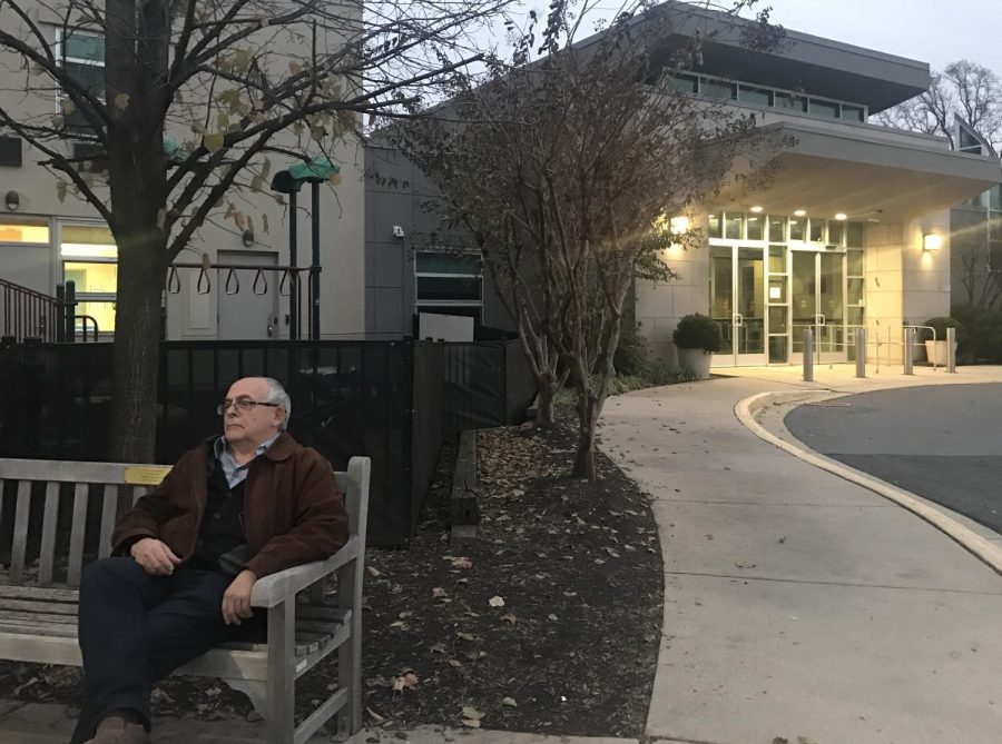 A man sits outside Congregation Beth El in Bethesda, MD. Beth El and many other synagogues have increased their security after recent shootings and hate crimes.