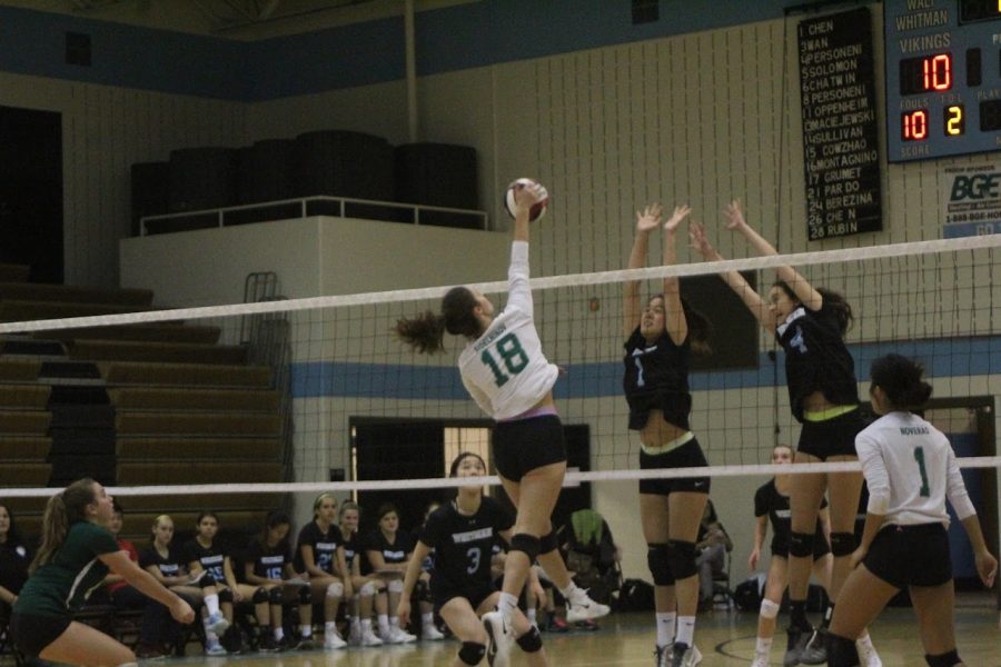 Senior Captain Elizabeth Sidelnikov rises up for the hit against two Whitman defenders. 
