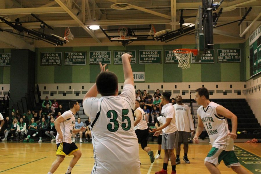 A teacher plays in the student/staff basketball game. The staff won the game by two points.
