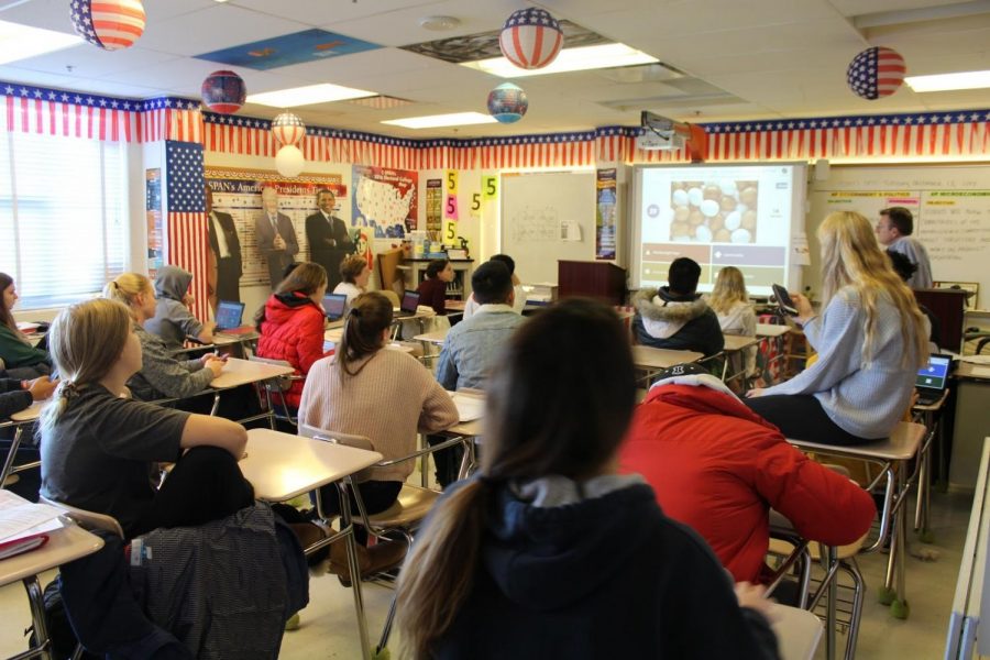 AP Government and Micro/Macroeconomics teacher Timothy Rodman prepares his Microeconomics students for an upcoming Unit Test. AP classes tend to move at a faster pace. 