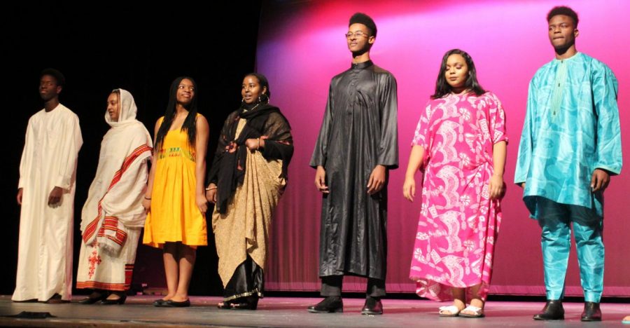 Students share vibrant aspects of black culture during the Black Student Unions annual cultural assembly. This years assembly elicited controversy over the decision to hold the assembly during an extended lunch period rather than the double third period schedule that has been used in years past. Pictured from left Ourmaroul Gueye (12), Eagla Tilahun (11), Paula Tinong (10), Juweriya Omar (11), Yerim Kone (11), Bethelehem Wossene (11), Oumar Farouk Adboulahi (12).