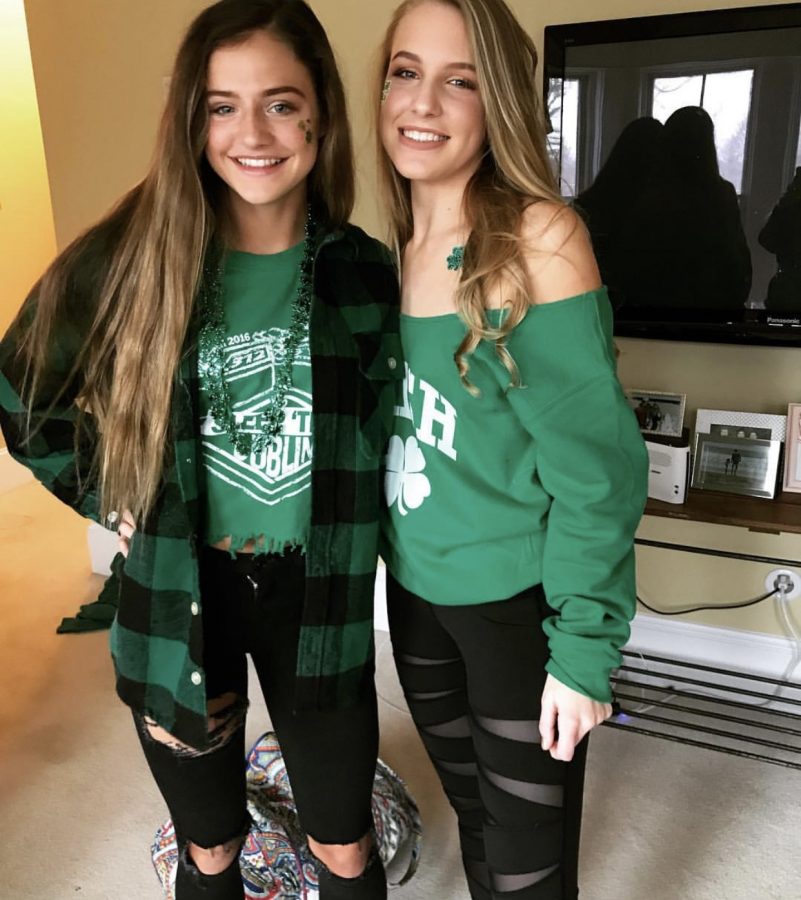 Juniors+Ally+Hilligoss+and+Brooke+Haines+sport+their+St.+Patrick%E2%80%99s+Day+spirit+with+four+leaf+clover+stickers%2C+green+necklaces+and+green+clothing.+The+girls+showed+up+to+ShamrockFest+with+a+big+group+of+friends+and+plan+to+attend+the+event+this+year+as+well.%0A