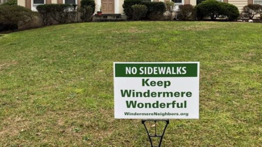 Nearly 70 mature trees will need to be cut down in Windermere alone to make way for sidewalk construction, which will only be on one side of the street. Residents are concerned about property value, the environmental impact, and the changing appearance of the neighborhood they call home. This photo shows a lawn poster that is now a common sight throughout the Windermere and Luxmanor neighborhoods.