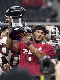 Kyler Murray lifting up the Big 12 Conference Championship trophy. Murray chose football over baseball.