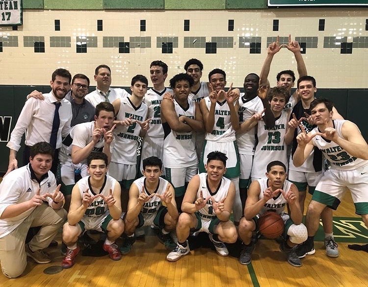 WJ+varsity+boys+basketball+team+hold+up+their+Ws+after+their+exciting+overtime+win+against+Walt+Whitman+High+School.+This+picture+was+taken+right+after+Coach+Parrish+had+received+the+call+about+being+invited+to+30+for+30%2C+so+the+boys+were+feeling+very+exhilarated+in+this+moment.+%0A%09%0A
