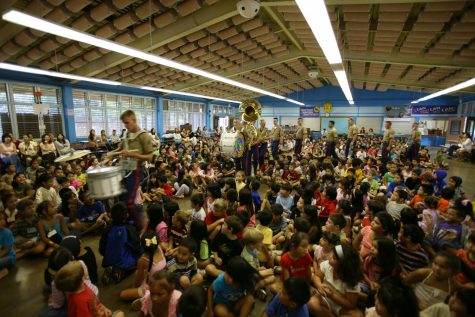 A bunch of WJ students sit in the cafeteria waiting for Jacob Daley to perform 