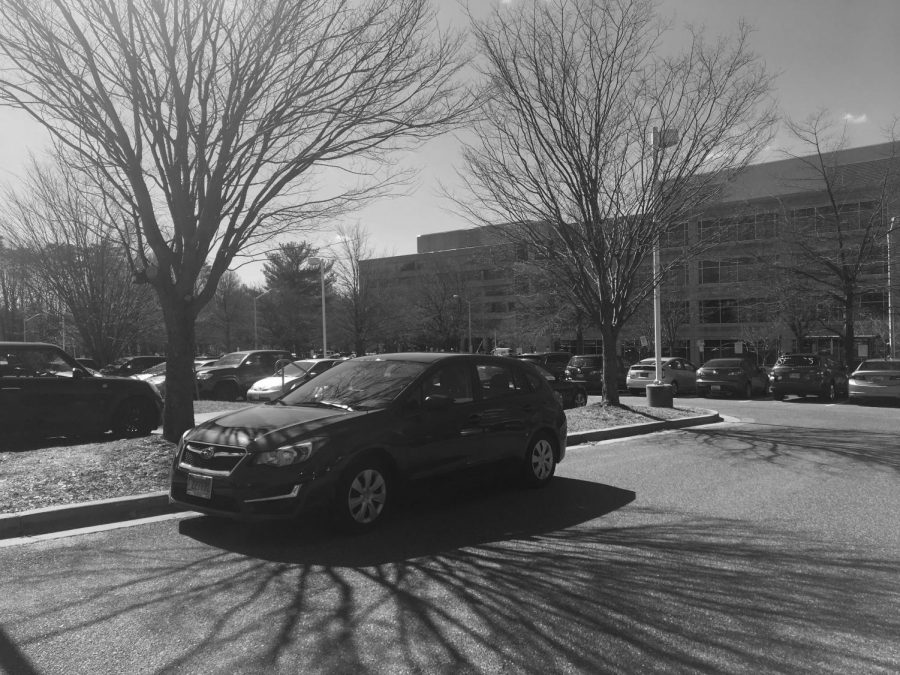 A student parks their car outside of a parking space. Due to the overwhelming amount of juniors who need parking spaces without  parking passes, students have resorted to alternative spaces. 