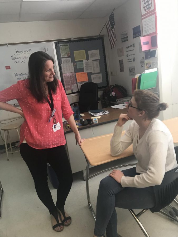 Math teacher Terri Bullock talks to Evelyn Hoon, one of her students. Many teachers try to build relationships with their students in order to prevent problems from occurring within the classroom. 