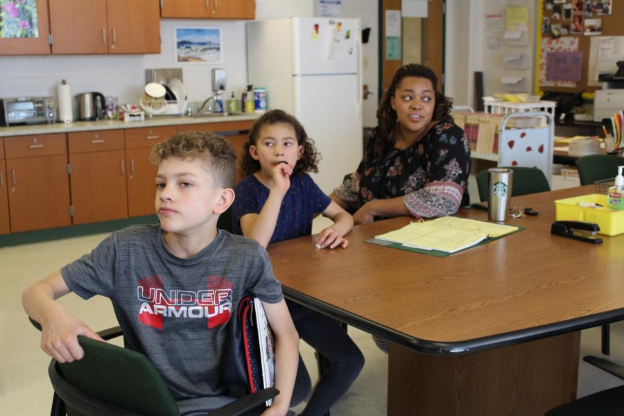 Eliana VanCuran and her children eat their lunch in the English office.