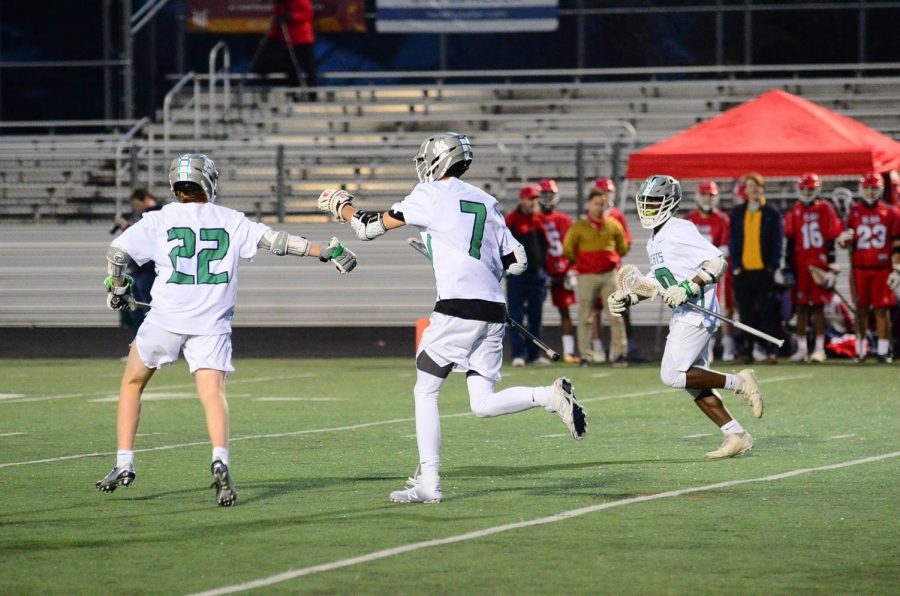 From left: teammates Matt Kroskin Jack Danco and Ethan Oyeniyi celebrate after goal scored against Montgomery Blair High School. 