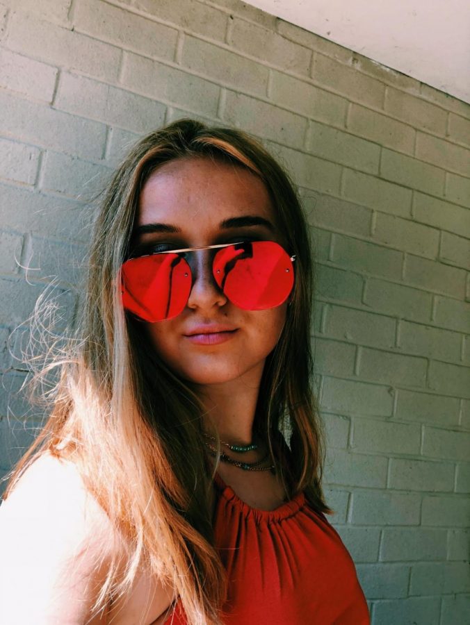 Junior Holly Darby tops off her outfit with a bold pair of red sunglasses. Photo courtesy of Holly Darby