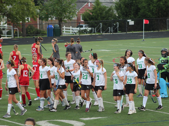 The JV girls field hockey floods the field after a seasonal game. This team is one of many that experiences the collide between sports and summer.