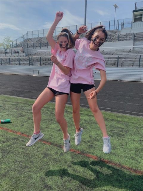 Ready set play. Juniors Kayla Kahrl and Caroline Kennon jump in excitement to play in WJ’s annual Powder Puff game against the seniors on May 22. The juniors played a close game, but ultimately lost.